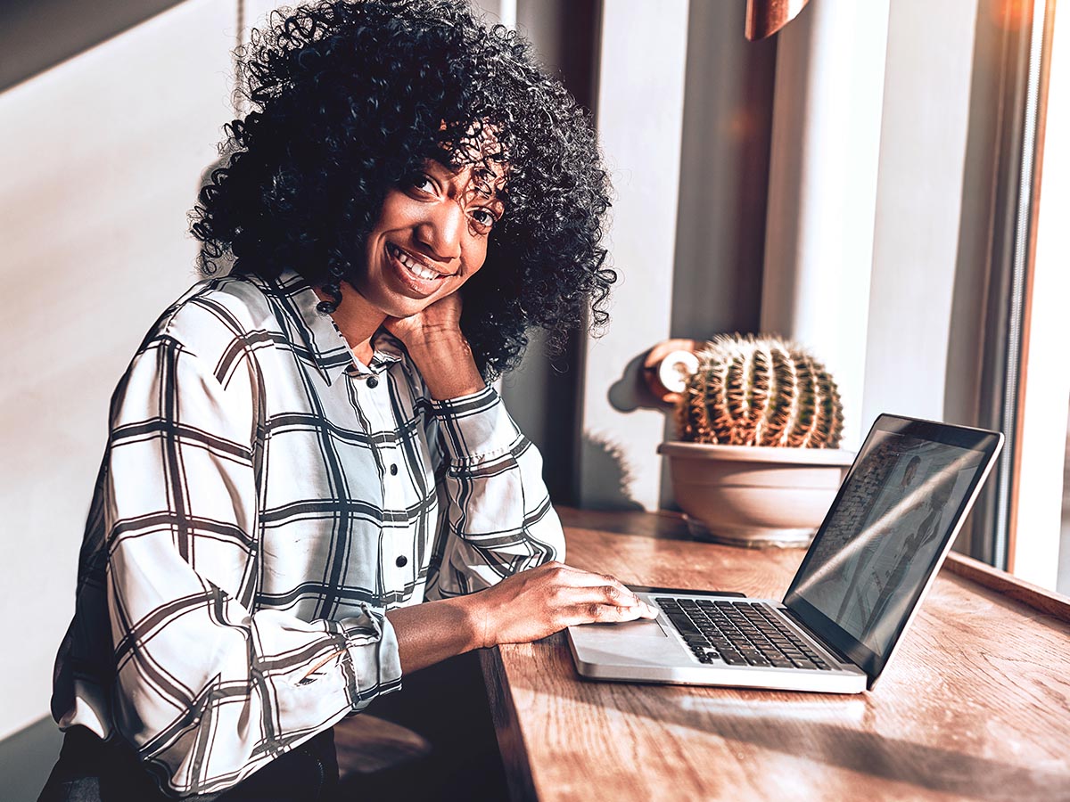 Woman smiling and using laptop